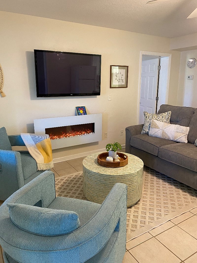 Living room with 50 (fire stick) tv and faux fireplace
