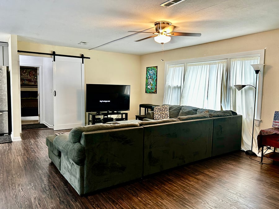 Open Living / TV Room facing entrance to Bedroom #1 and to the laundry room/ Deep Freezer Room