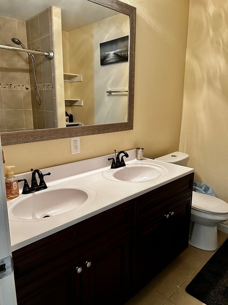 Largest room has attached private bathroom with double sinks and tub/shower combo