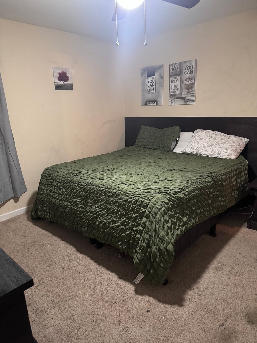 Bedroom two the second bedroom that has a king size bed also has a private half bathroom that's a sink in a toilet and also a walk-in closet full dresser also smart TV mounted on wall all TVs