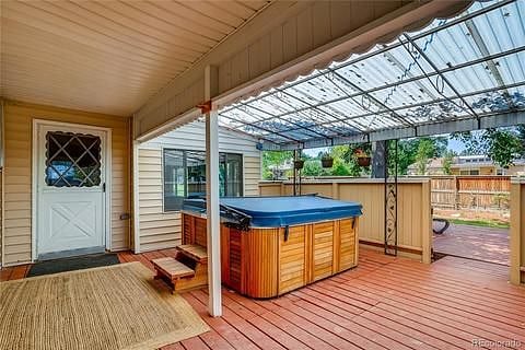 Hot tub on covered back porch. 