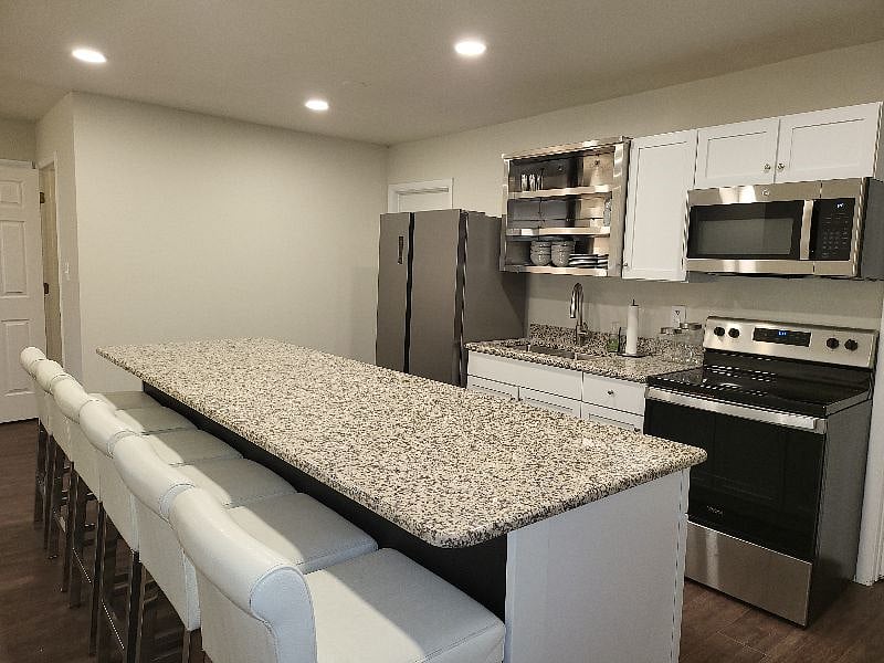Beautiful expansive kitchen with Stainless appliances including dishwasher. Granite countertop bar seating.