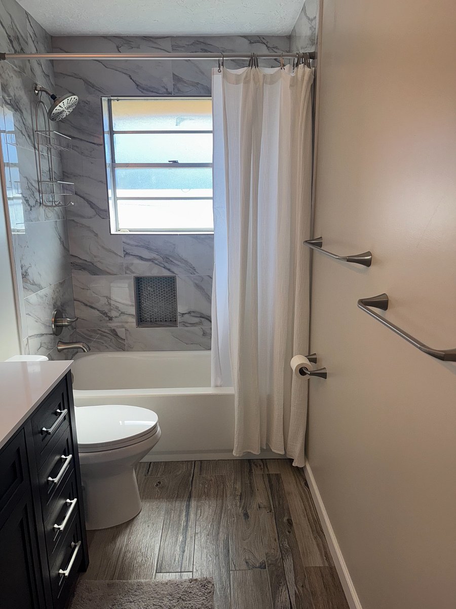 Primary ensuite bathroom with shower and deep soak bathtub.