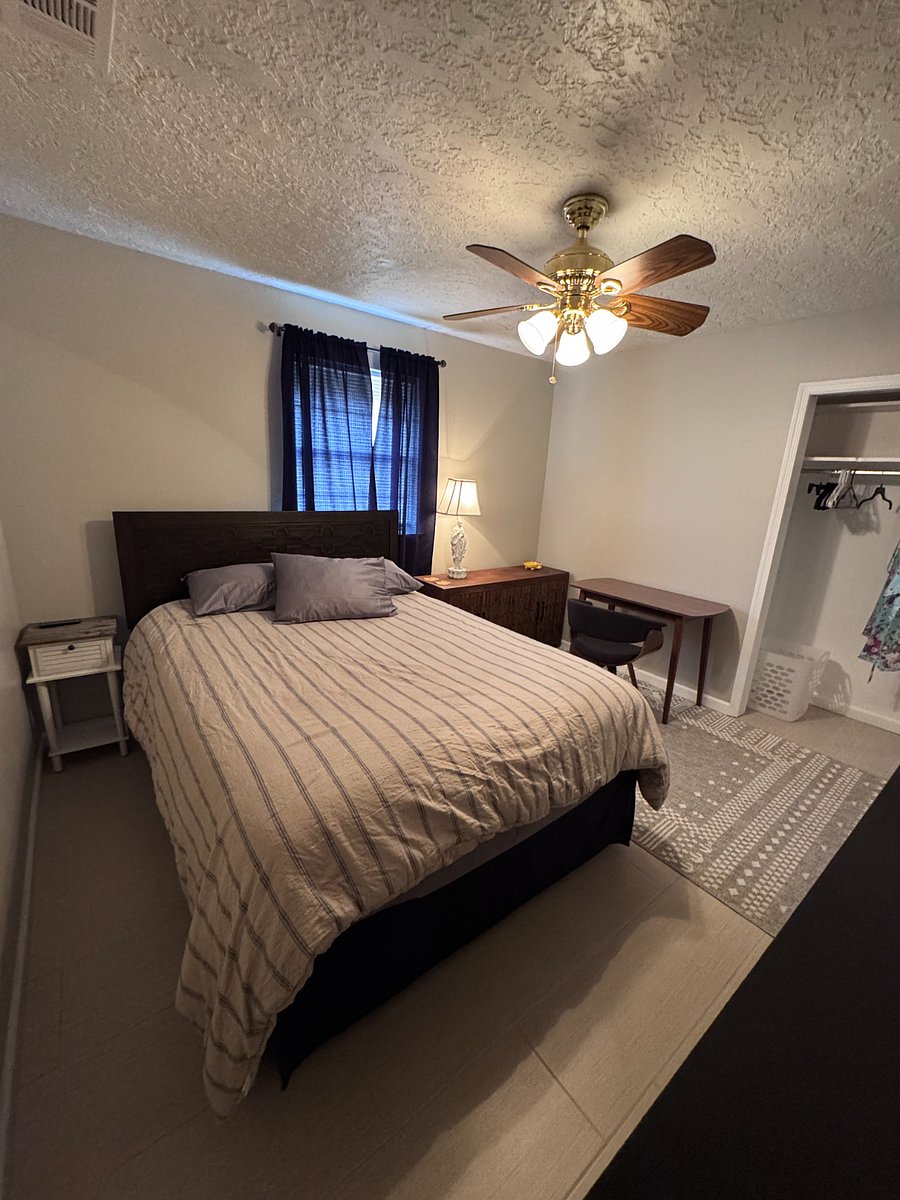 Spacious second bedroom with Queen bed, office space, and T.V.
