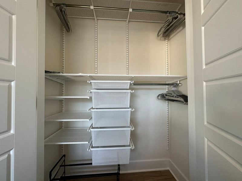 Elfa closet system from the Container Store provides lots of storage and hanging space.