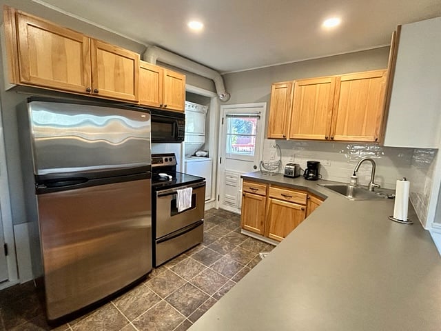 Full kitchen with full sized fridge/freezer, oven, dishwasher, toaster and coffee maker. Plus knives, plates, bowls, cups, silverware, baking sheets, cooking utensils, crockpot and blender
