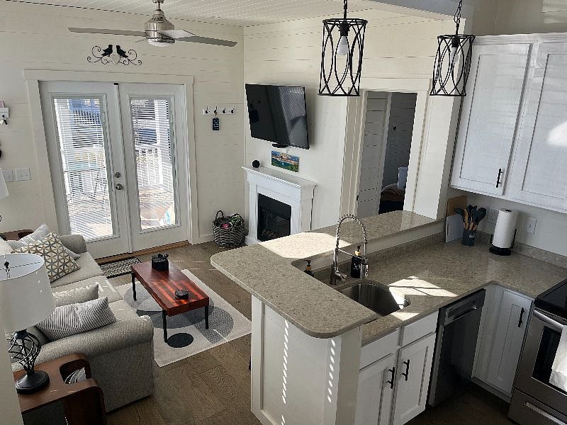 Looking at the living and kitchen from the stairs to the loft