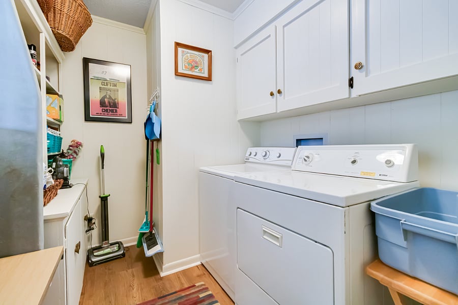 Well equipped laundry room and storage for cleaning supplies