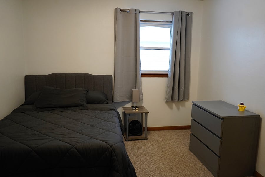 Second bedroom. Blackout curtains, basic workout equipment, fan.