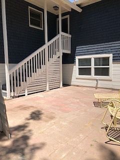 Large Private Patio with stairs to house and attached garage
