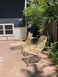 Ground level patio used by upper level guests. Access from side of house as well as back stairs.