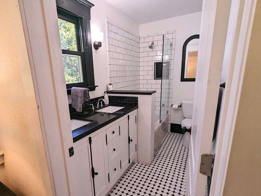 Remodeled en suite bathroom off master bedroom with tub/shower and double vanity.