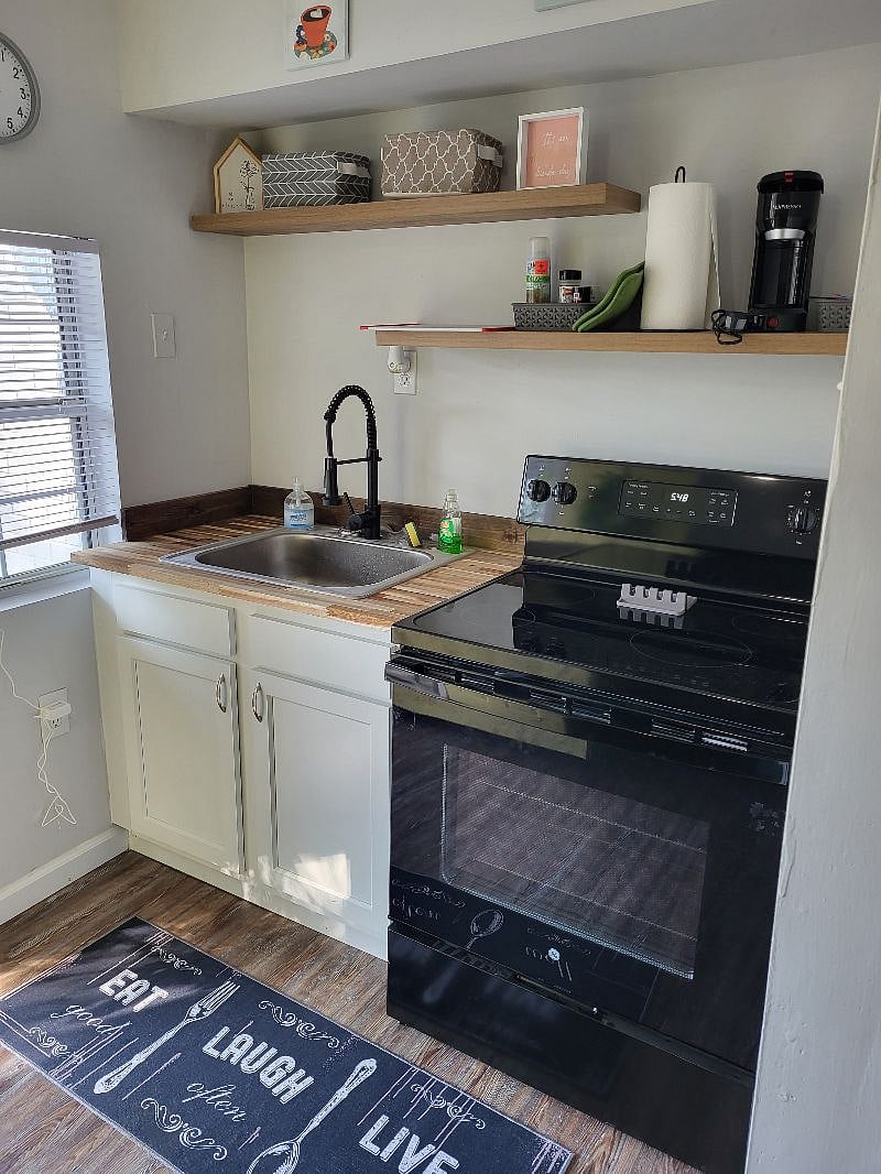 Kitchen - full size range, fridge, microwave and large airfryer. Stocked with all cooking/baking needs. Large pantry off kitchen for food and cleaning tools storage. 