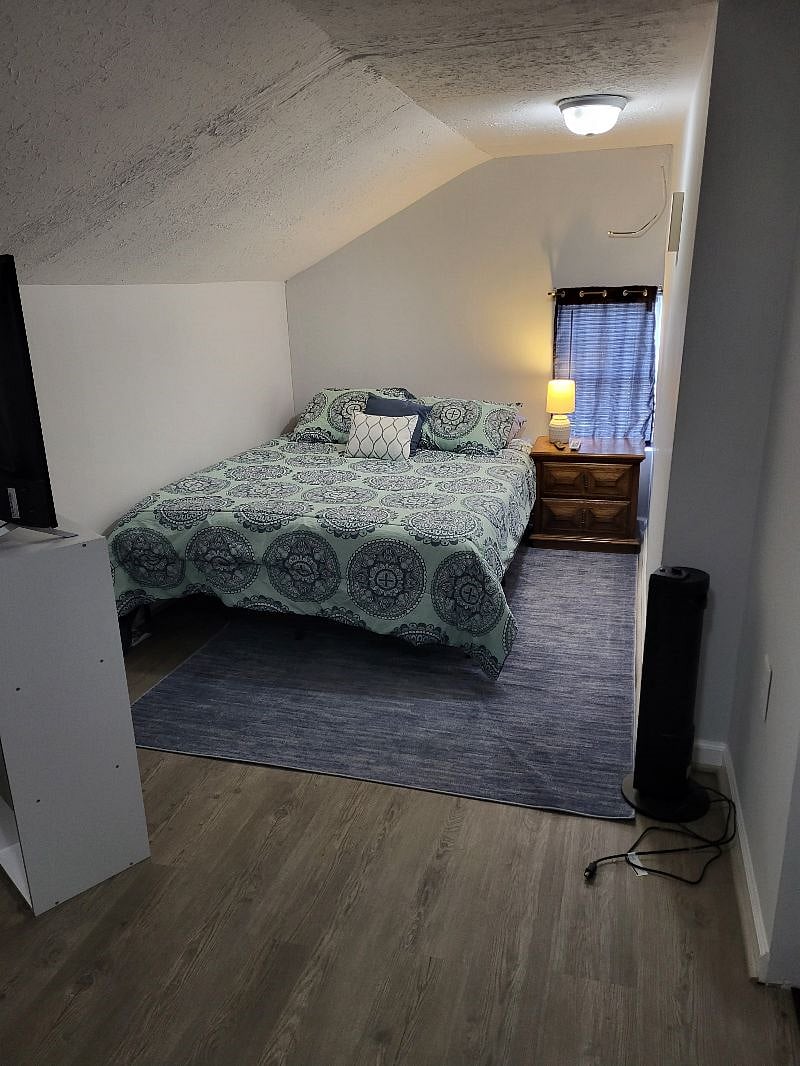Bedroom is upstairs. Large room with 2 dressers, 4'x4' closet and night stand. Queen bed and smart tv. Upstairs has own temperature control. Bathroom is off bedroom. 