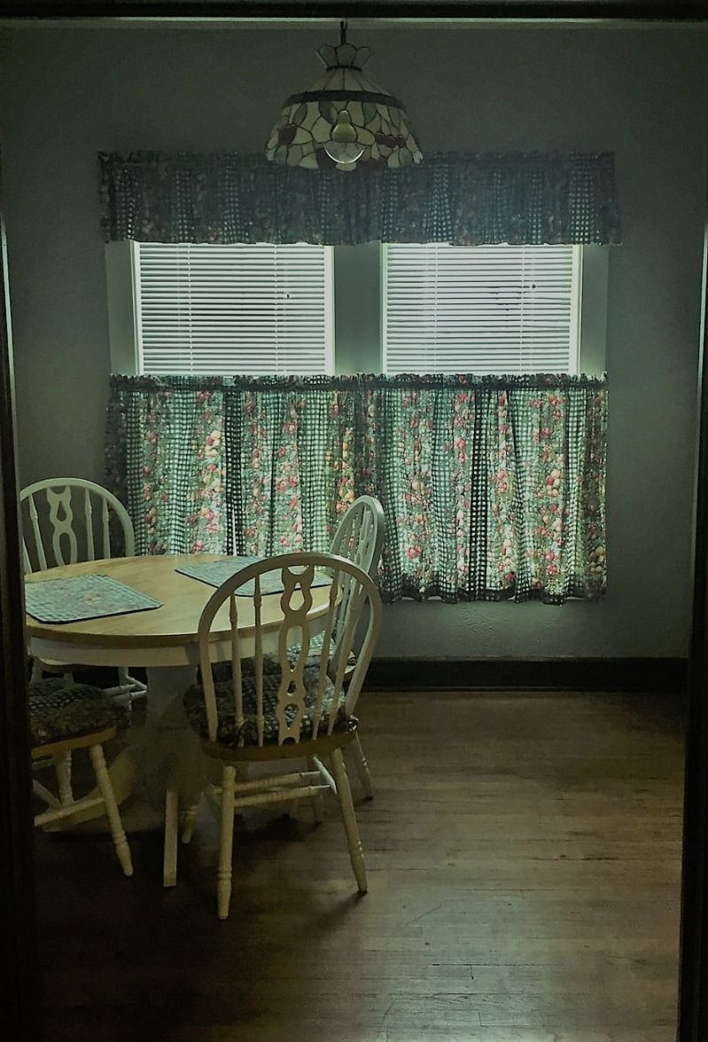 Dining Area with table and four chairs. Built-in storage hutch/small countertop