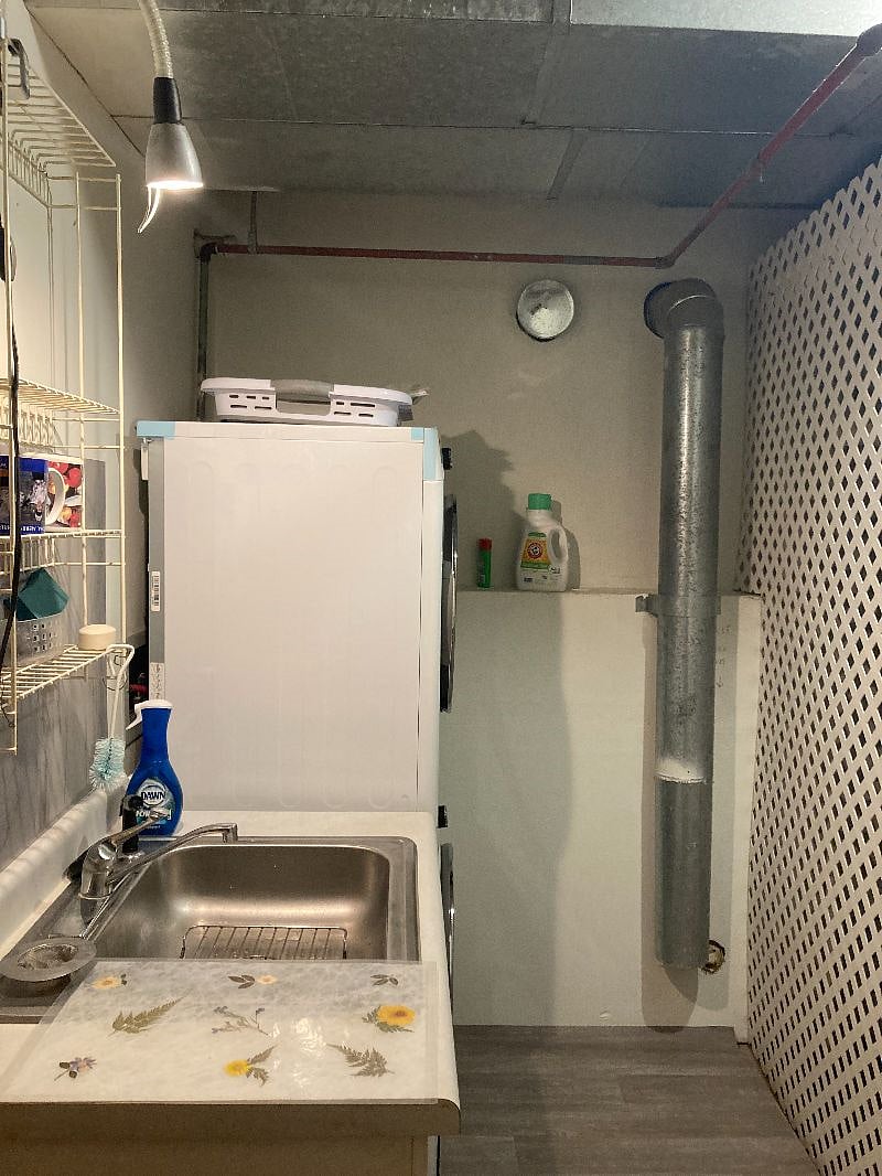 A laundry room with a kitchen sink.