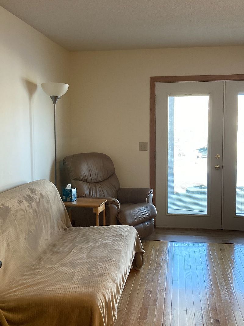 A living-room futon convertible to a queen size bed and a recliner.