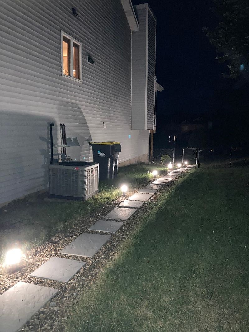 A walkway to the fenced back yard (summer late at night)