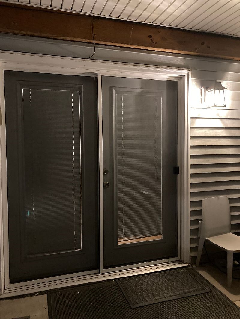 The unit entrance from the patio in the evening - well lit with a dusk-to-dawn outside lantern.