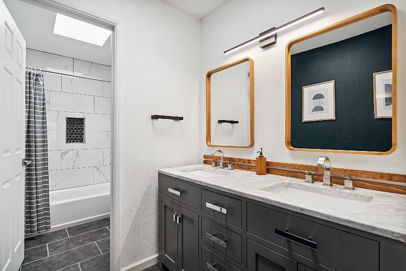 Newly renovated primary bathroom with double sinks and skylights.