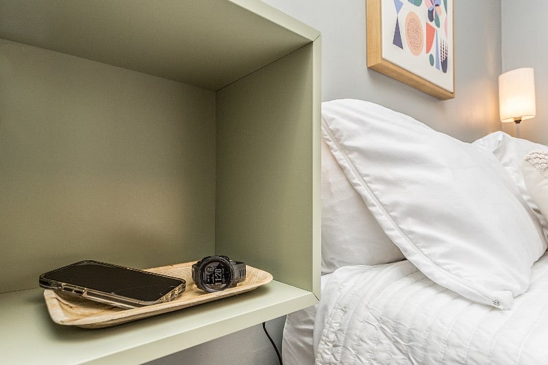 Bedside cubbies for keeping your devices and jewelry. Bedside lighting for reading.