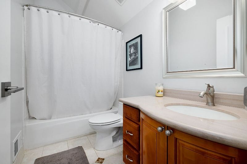 The upstairs master bedroom conveniently connects to an exterior private bathroom with a shower.