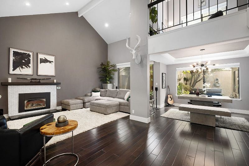 Enjoy a stunning living and dining space with an open, airy design and beautiful window views.
Just above, a charming home office loft on the second floor overlooks the area, offering a cozy yet functional workspace with a picturesque backdrop