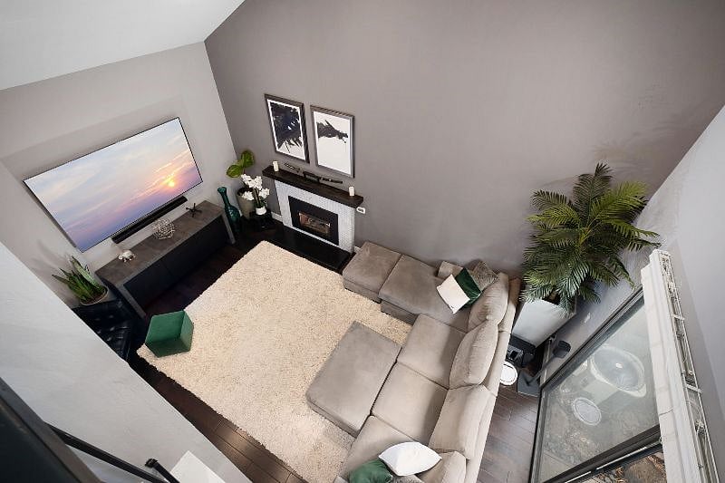 Experience the inviting charm of this spacious living room, centered around a plush, oversized couch perfect for reclining and letting the day's stress melt away.
With its open feel and comfortable seating, it's an ideal spot to relax and recharge.