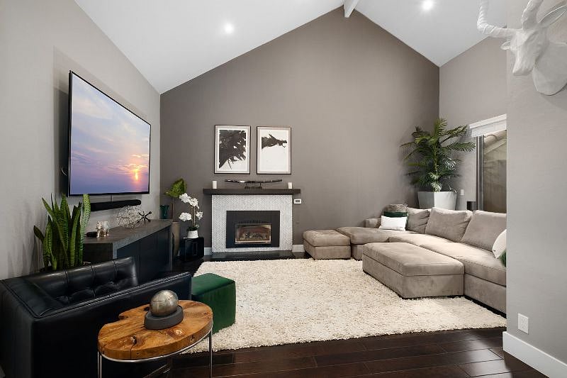 Enjoy a stunning living and dining space with an open, airy design and beautiful window views.
Just above, a charming home office loft on the second floor overlooks the area, offering a cozy yet functional workspace with a picturesque backdrop