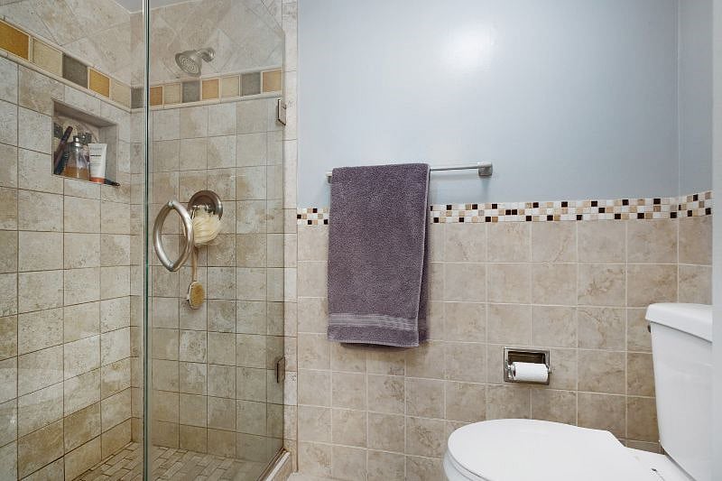 Master ensuite bathroom, complete with a sleek dual-sink countertop and a walk-in shower, creating the perfect blend of style and functionality for your stay.