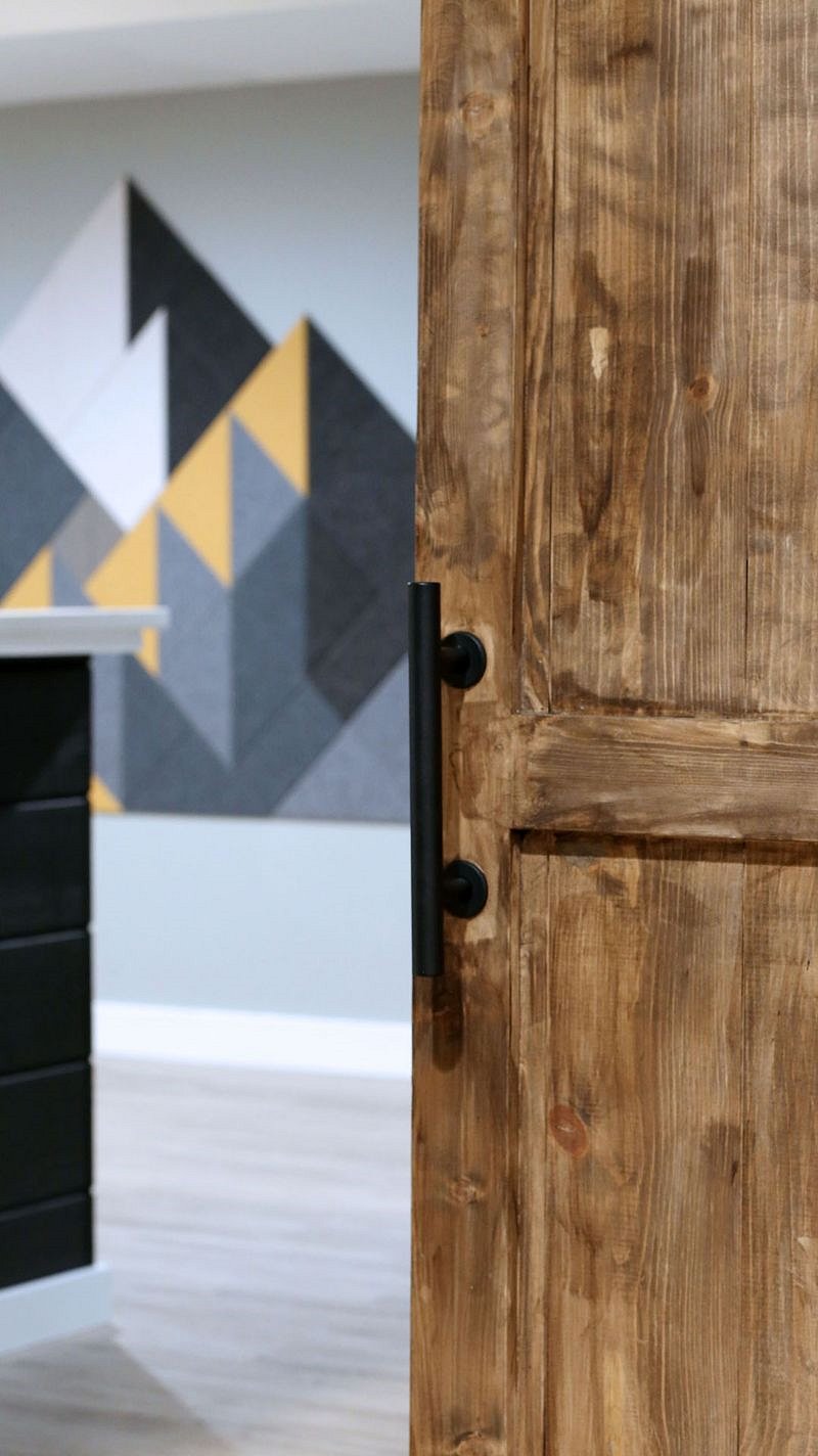 Custom barn door leading to bar/living room
