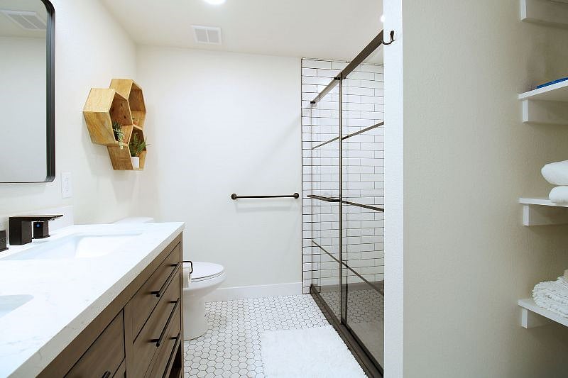 Bath 1 - double sink vanity w/ Vanity lighting (make up lighting), walk-in full tile shower
