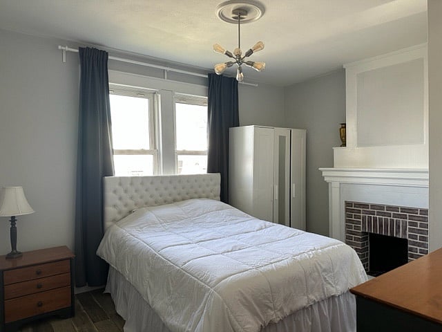 Bedroom 1 with non-working fireplace
