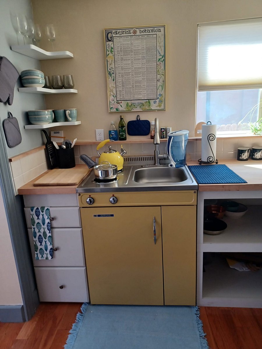 Chic vintage 2 burner stove top kitchenette with extra large mini-fridge & freezer. There is plenty of extra kitchen storage for perishables under the counter.