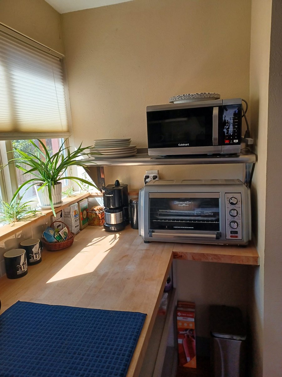 Our kitchen is complete with a toaster oven airfryer combo, microwave, coffee maker/grinder/beans