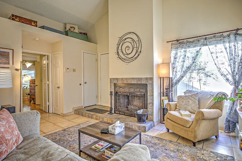 Relax in a beautiful living room with dramatic 20-foot vaulted ceilings.