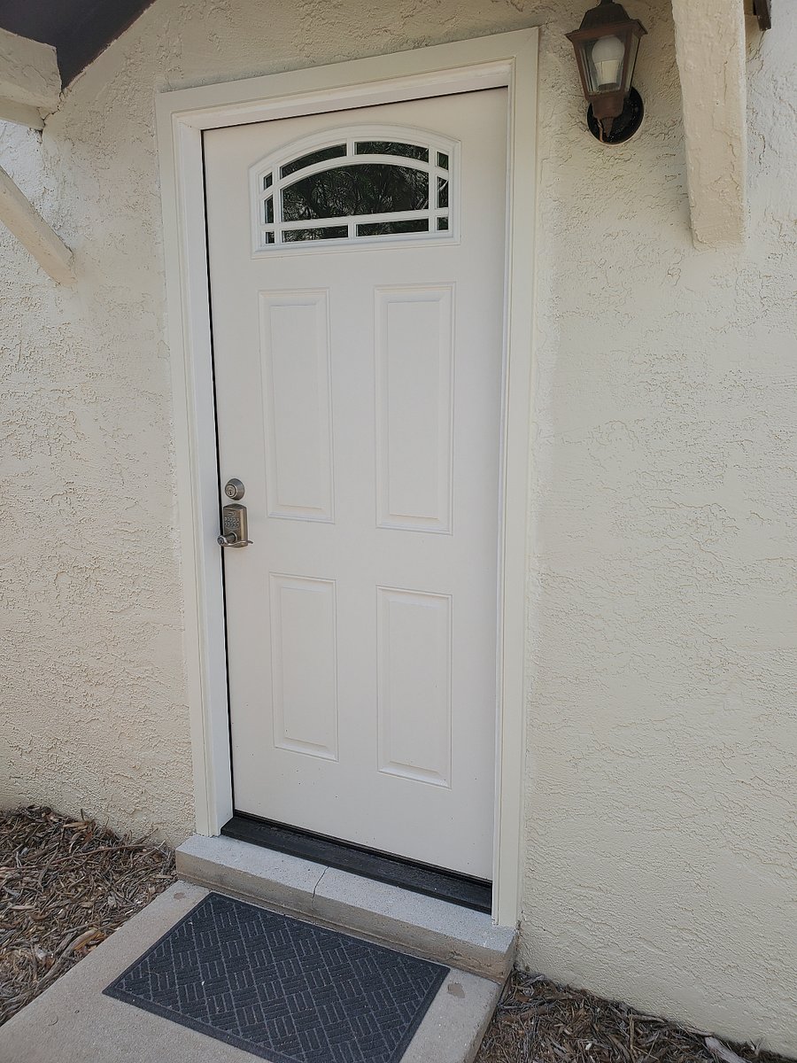New insulated front door with modern keyless entry for secure, hassle-free access.