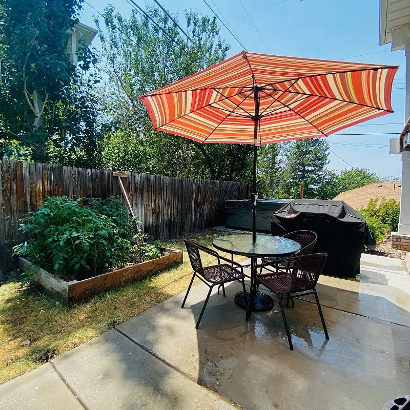 Your private patio area with a small table, umbrella, and gas BBQ
