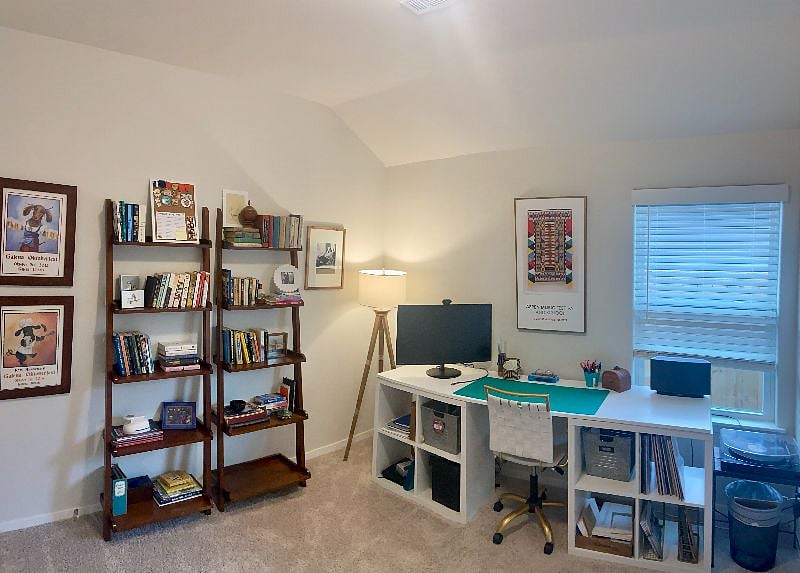 private office includes large desk, monitor, library, and record player with small vinyl collection (pop, rock, jazz, folk)