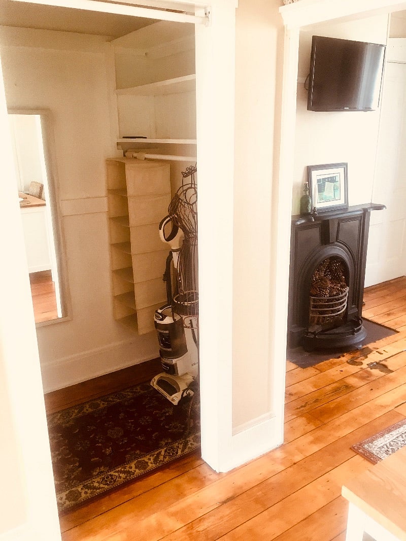 Full walk in closet with mirror vacuum, laundry basket etc.