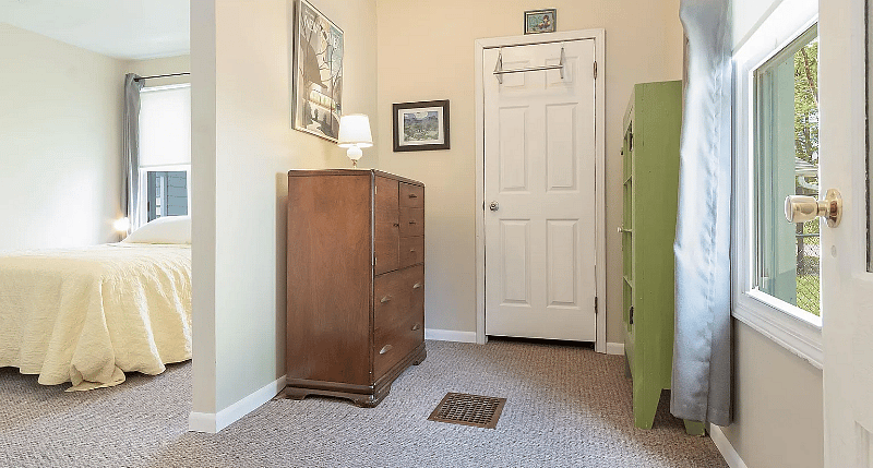 Entry room into master bedroom. L-R: dresser, additional closet w/iron & ironing board & cabinet w/extra linen.