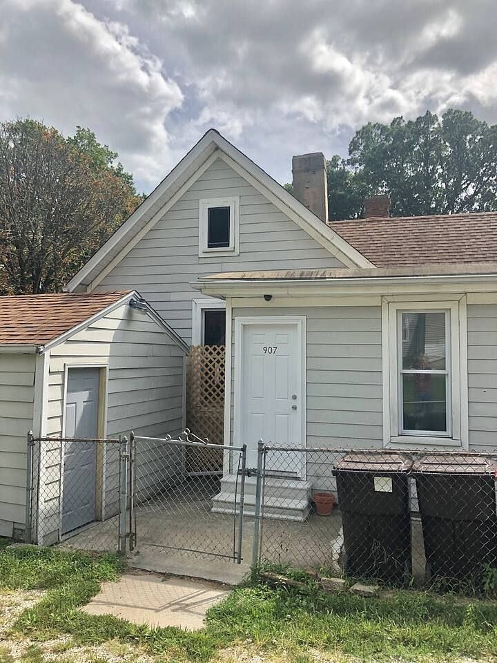 Back of house w/keypad entry backdoor & single car garage on the left w/remote.