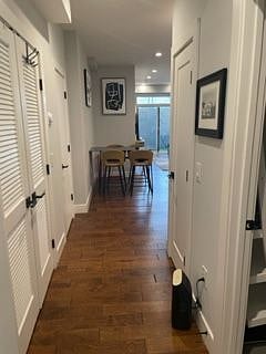 Hallway from bedroom to living room passing the bathroom and laundry area.
