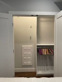 Bedroom closet with custom closet system to maximize storage.