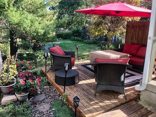 Fenced in backyard with comfortable lounge chairs, firepit and relaxing fountain.