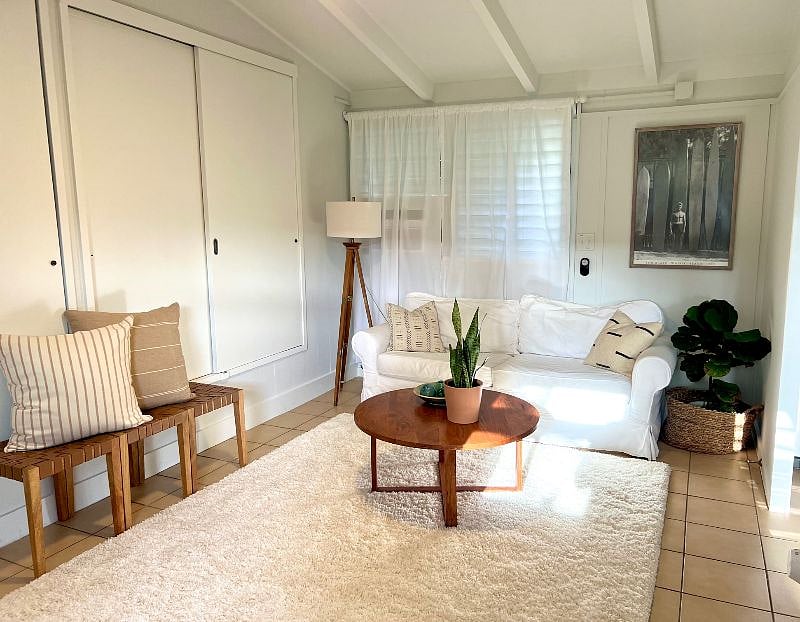Living room upon entry with TONS of storage, cozy Pottery Barn couch, TV, and lots of space to stretch or workout.