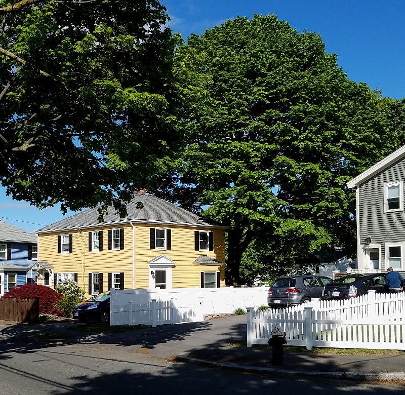 The townhouse is the right (closer) half of the yellow building.