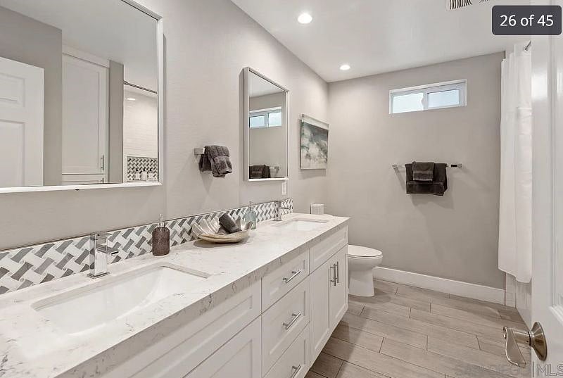 Double vanity bathroom with tub and shower.