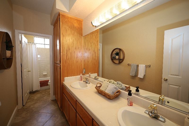Shared bathroom, private toilet, and shower, dual sinks