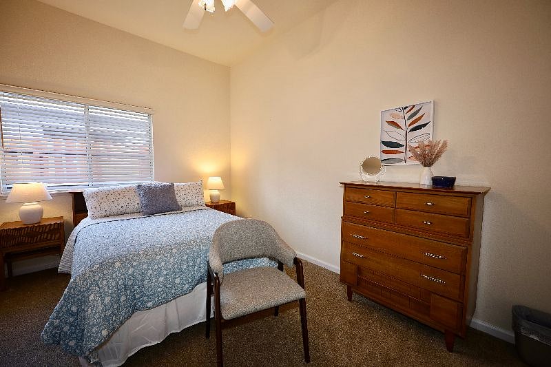 Bedroom 1 with Full bed, linens, closet, dresser, and seat